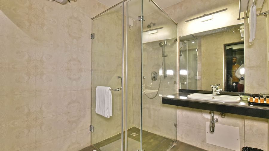 Modern glass-enclosed shower cubicle at DLS Hillcrest Resort, Shimla.